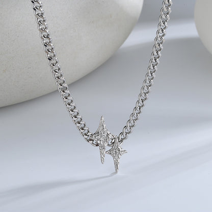 A silver star necklace with a pattern