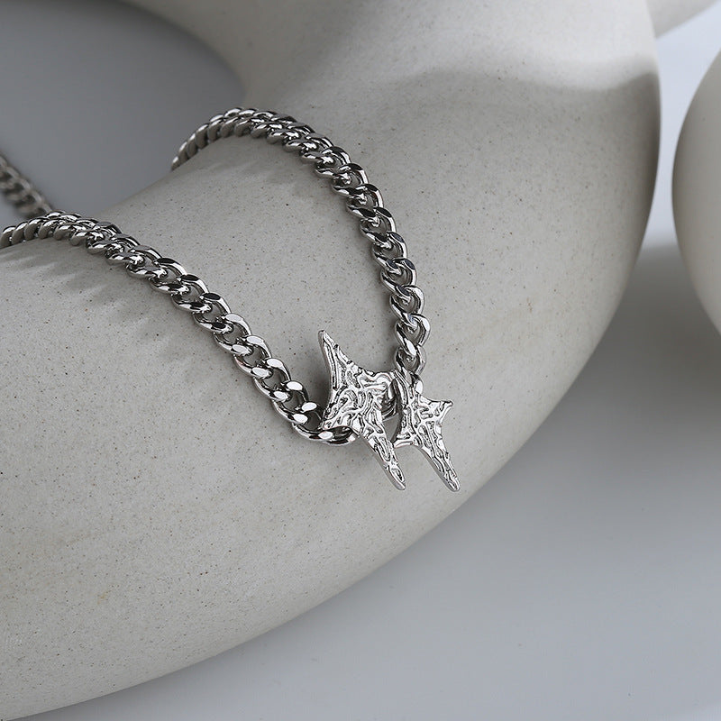 A silver star necklace with a pattern