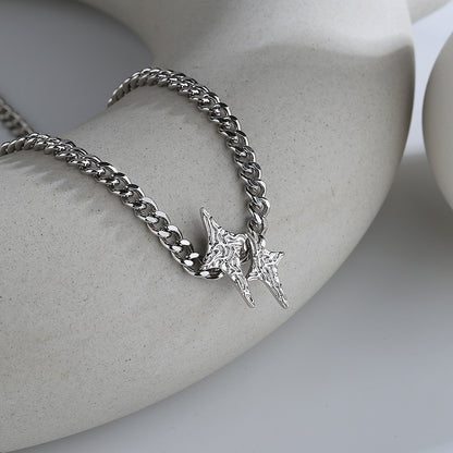 A silver star necklace with a pattern