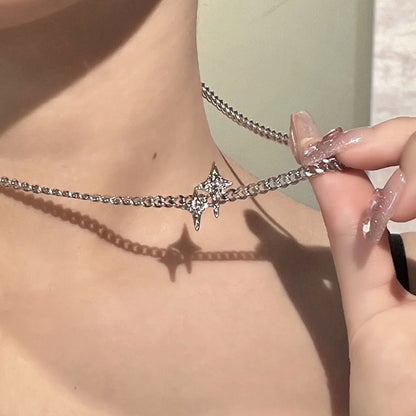 A silver star necklace with a pattern